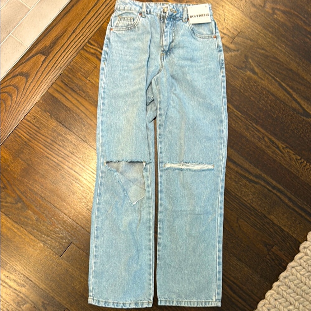 Supre Light Blue Distressed Women Jeans. Mid rise, relaxed leg, rigid denim.